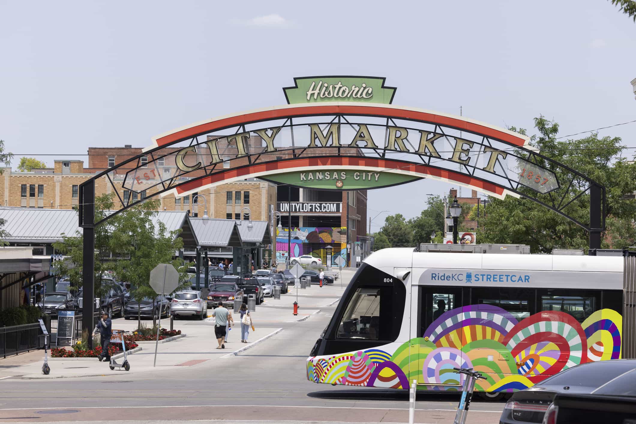 The Kansas City streetcar drives past the welcome Historic City Market sign in Kansas City, Missouri.